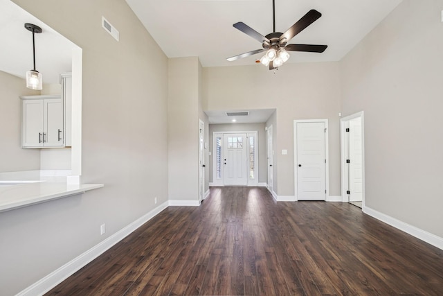 foyer with dark wood-type flooring, a high ceiling, and ceiling fan