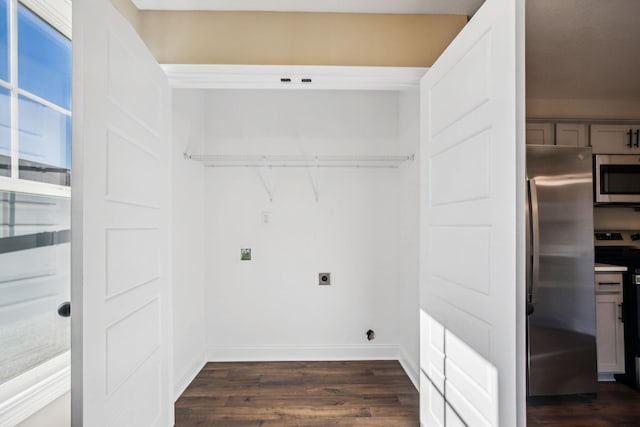 laundry area featuring dark hardwood / wood-style flooring and hookup for an electric dryer