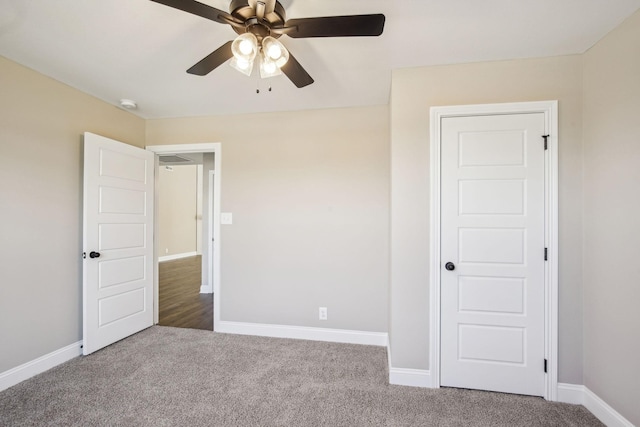 unfurnished bedroom featuring ceiling fan and carpet