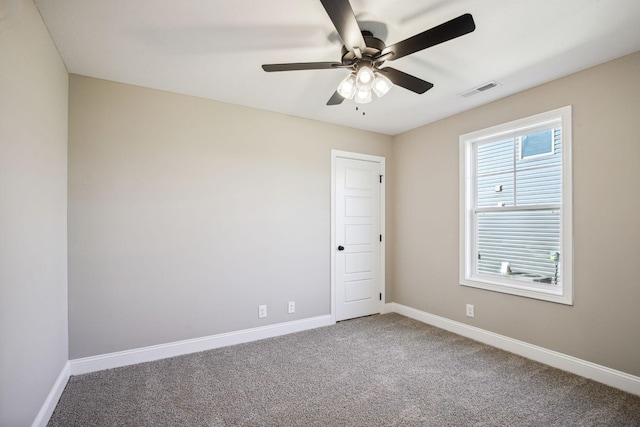 carpeted spare room with ceiling fan