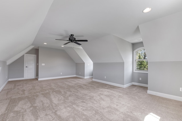 additional living space featuring lofted ceiling, light colored carpet, and ceiling fan