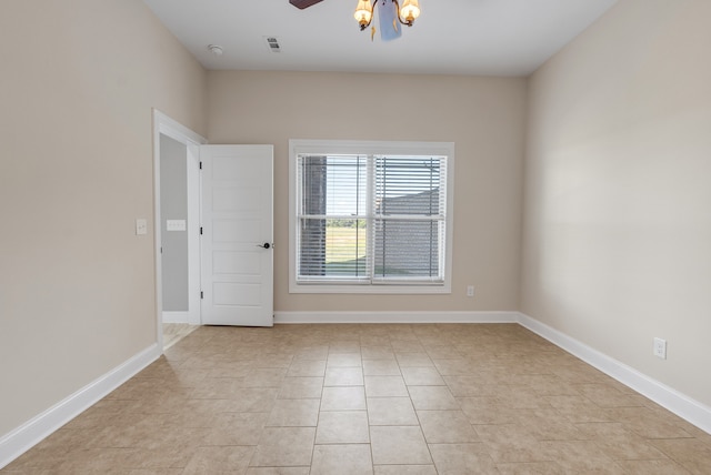 unfurnished room with ceiling fan and light tile patterned flooring