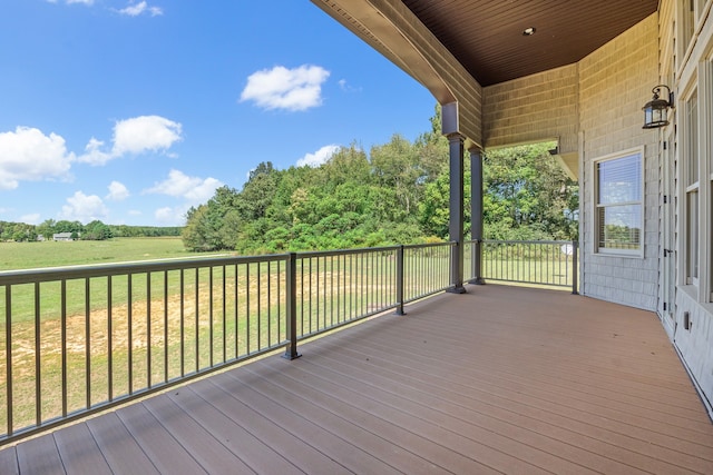 wooden deck featuring a lawn