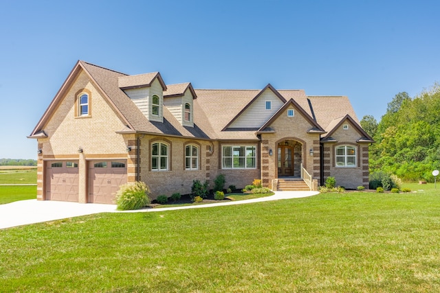 view of front of house featuring a garage and a front lawn