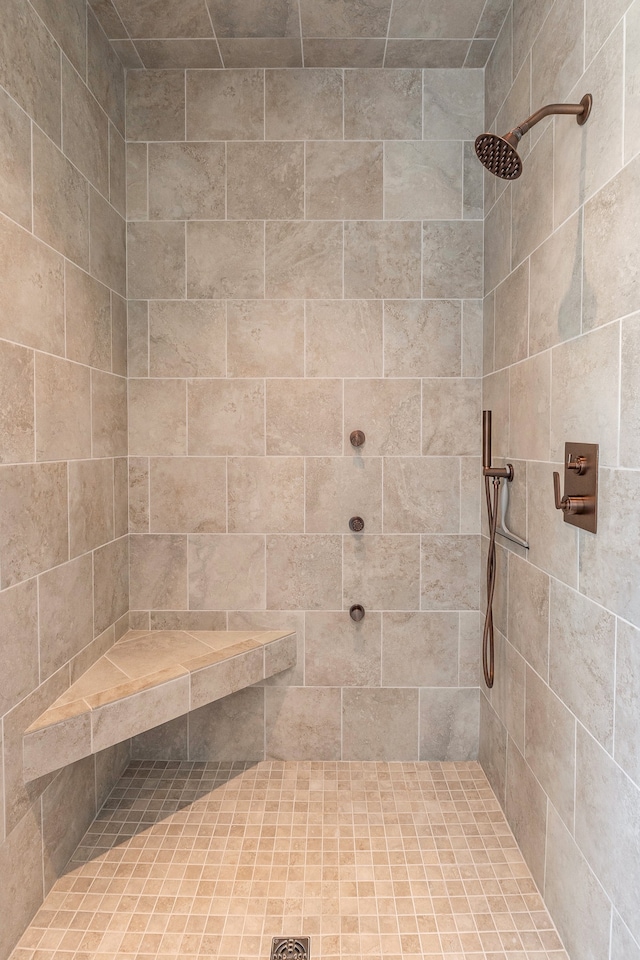 bathroom with a tile shower