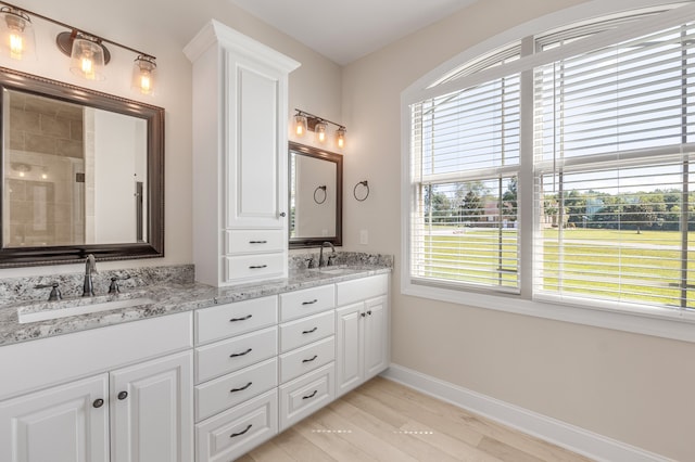 bathroom featuring hardwood / wood-style floors, an enclosed shower, and vanity