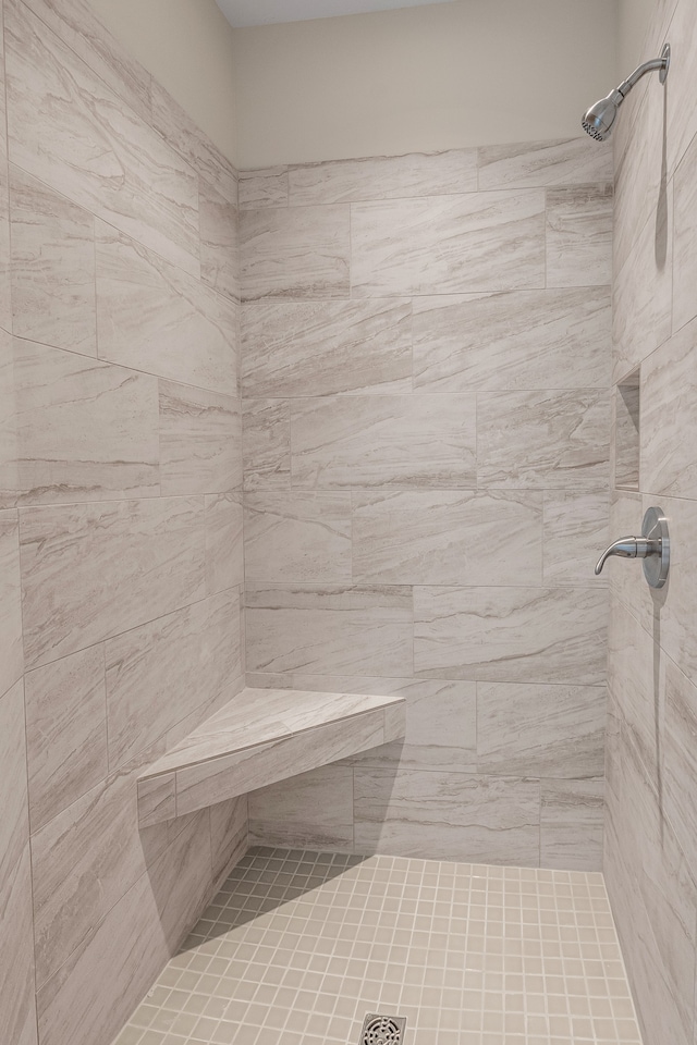 bathroom with a tile shower