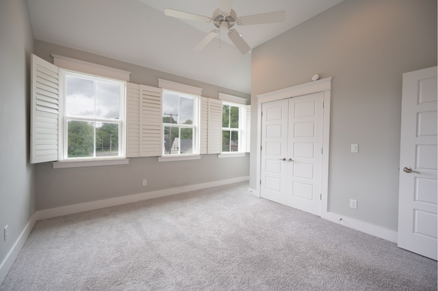 unfurnished bedroom featuring carpet, ceiling fan, and a closet