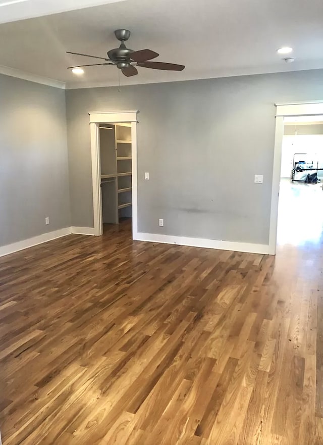 spare room featuring ornamental molding, hardwood / wood-style flooring, and ceiling fan