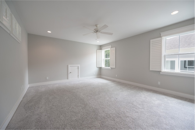 spare room featuring carpet flooring and ceiling fan