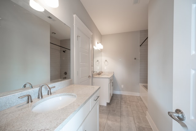 bathroom with vanity and tiled shower / bath combo