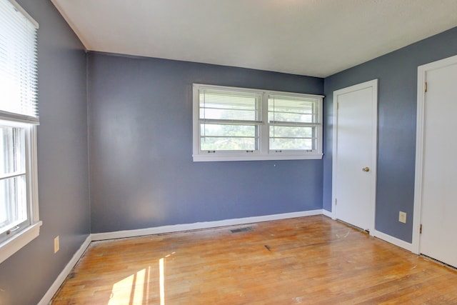 unfurnished room featuring light hardwood / wood-style floors and plenty of natural light