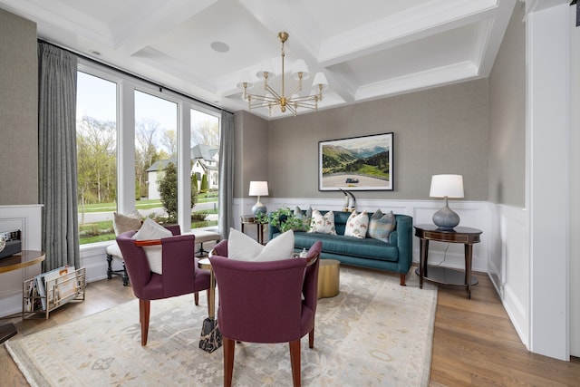 interior space with coffered ceiling, an inviting chandelier, beamed ceiling, and light hardwood / wood-style flooring