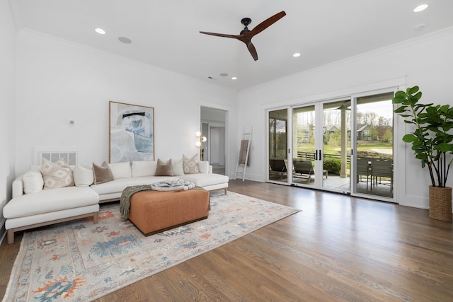 living room featuring ornamental molding, ceiling fan, and dark hardwood / wood-style floors