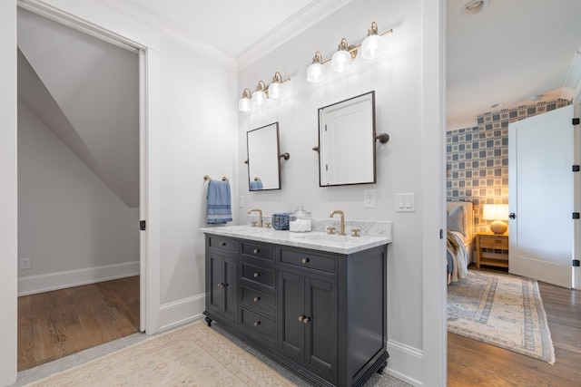 bathroom with crown molding, vanity, and wood-type flooring