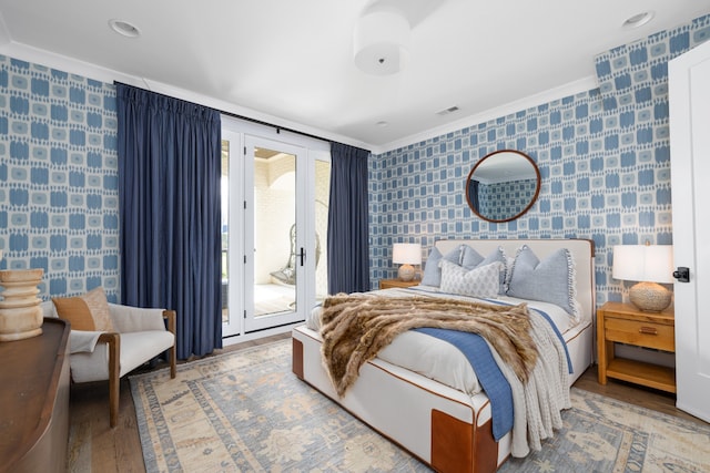 bedroom with french doors, ornamental molding, hardwood / wood-style flooring, and access to outside