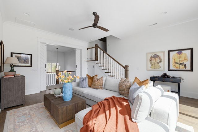 living room with ceiling fan, light hardwood / wood-style floors, and ornamental molding