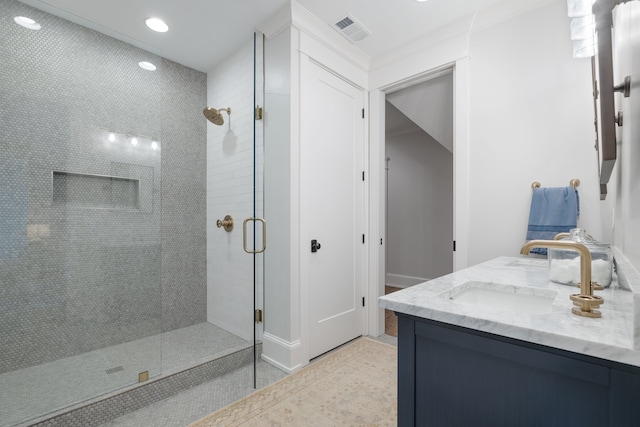 bathroom with tile patterned floors, walk in shower, and vanity