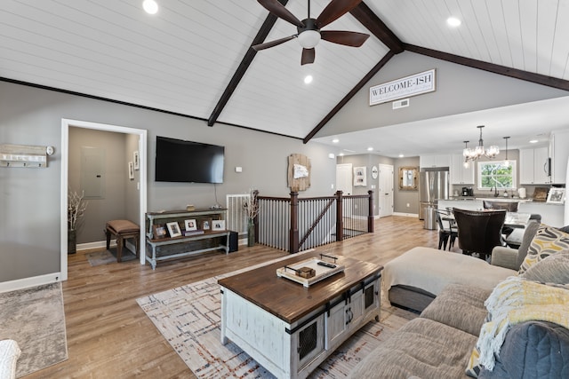 living room with wooden ceiling, light wood-type flooring, ceiling fan with notable chandelier, high vaulted ceiling, and beam ceiling