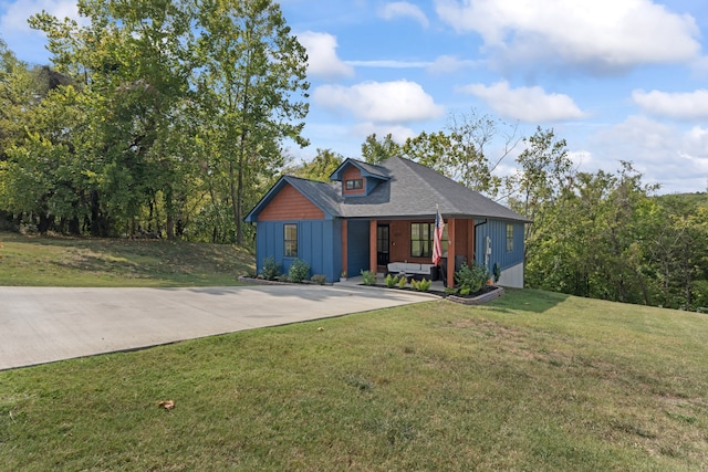 view of front of home with a front yard and covered porch