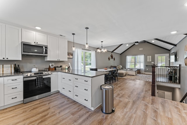 kitchen featuring white cabinets, stainless steel appliances, and lofted ceiling with beams