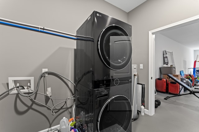 laundry area featuring stacked washer and clothes dryer