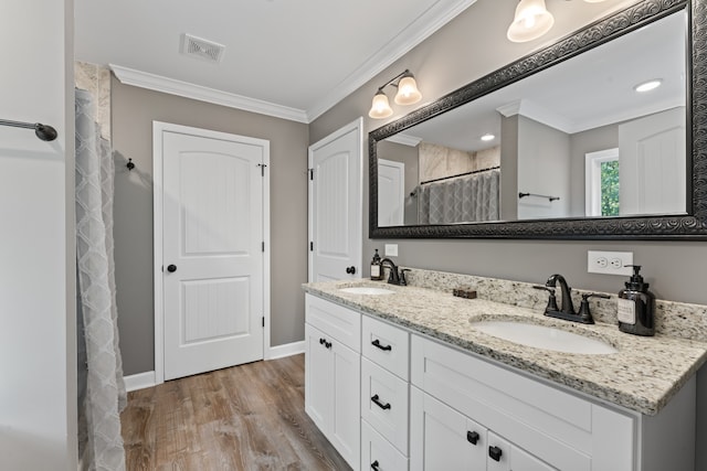 bathroom with crown molding, vanity, wood-type flooring, and curtained shower