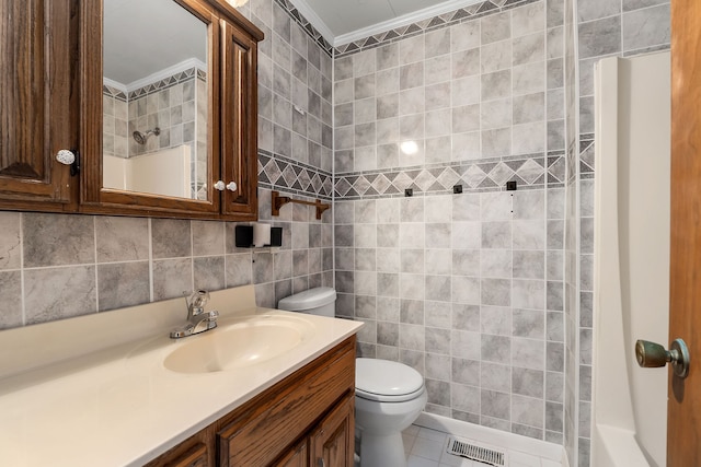 bathroom with toilet, walk in shower, ornamental molding, vanity, and tile walls