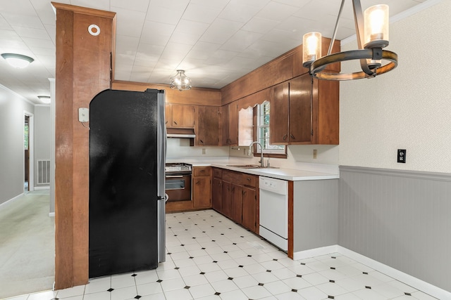 kitchen with white dishwasher, sink, black refrigerator, range with electric cooktop, and ornamental molding