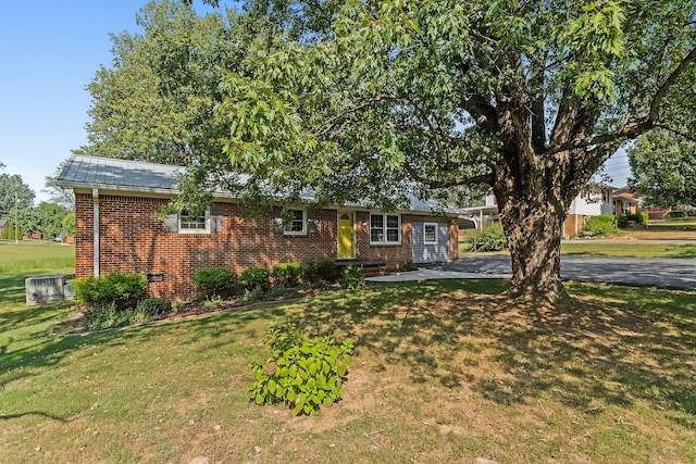 single story home featuring a patio, central AC unit, and a front lawn