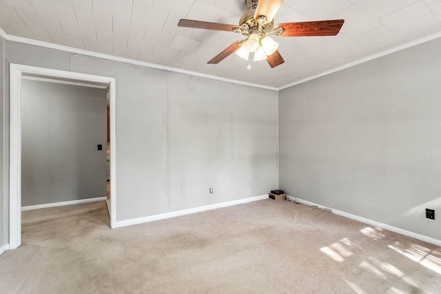 carpeted empty room featuring crown molding and ceiling fan