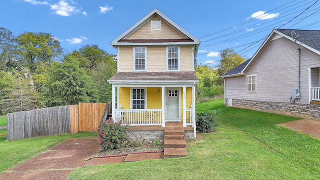 front facade with covered porch and a front yard