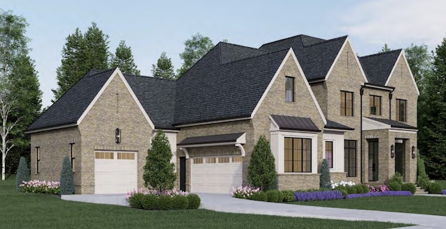 view of front of home with a garage and a front lawn