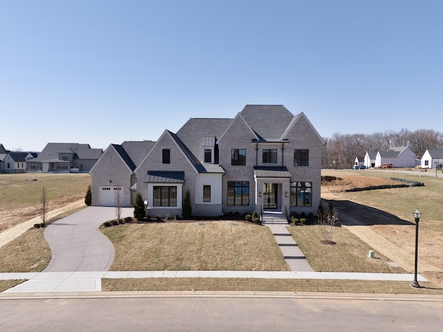 french provincial home featuring concrete driveway, a garage, and brick siding