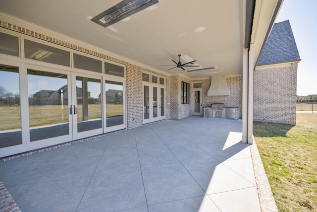 view of patio / terrace featuring french doors, exterior kitchen, and a ceiling fan