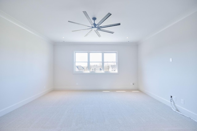 spare room featuring baseboards, recessed lighting, ceiling fan, crown molding, and light colored carpet