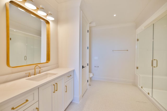 bathroom with vanity, baseboards, ornamental molding, a shower stall, and toilet