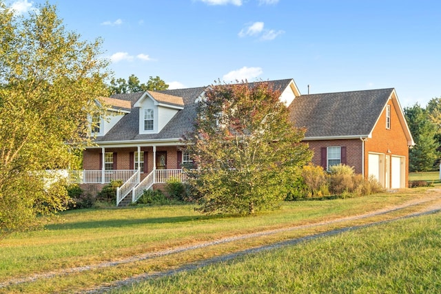 cape cod house featuring a porch, roof with shingles, a front yard, a garage, and brick siding