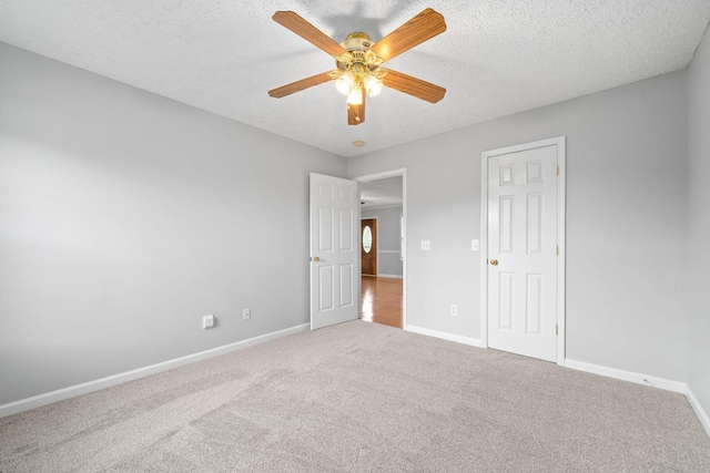 unfurnished bedroom featuring carpet floors, a ceiling fan, and baseboards