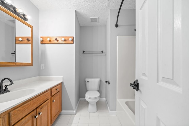 full bathroom featuring vanity, toilet, tile patterned floors, a textured ceiling, and baseboards