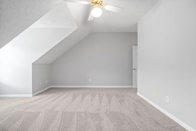 bonus room featuring carpet floors, a textured ceiling, and vaulted ceiling
