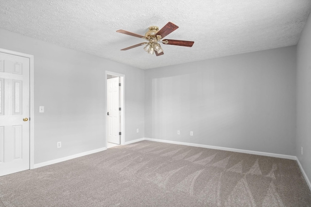 carpeted spare room with a ceiling fan, a textured ceiling, and baseboards