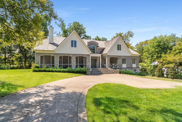 view of front of home with a porch and a front lawn