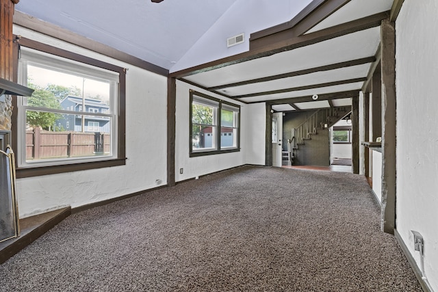 interior space with plenty of natural light, carpet flooring, and vaulted ceiling