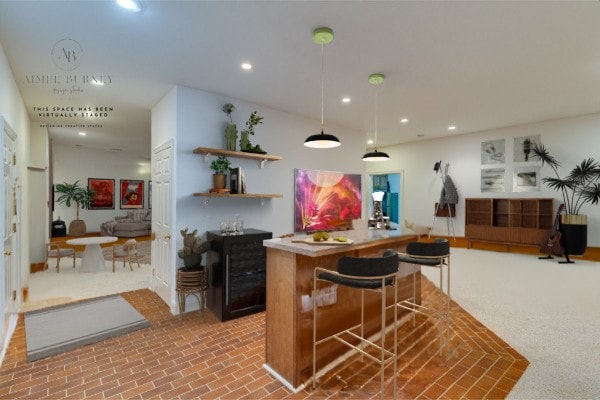 kitchen featuring pendant lighting and carpet floors