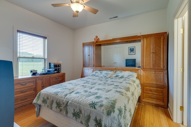 bedroom with ceiling fan and light hardwood / wood-style floors