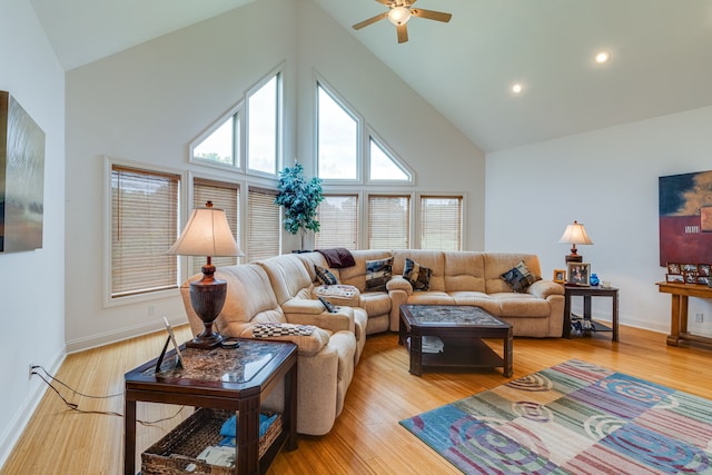 living room with ceiling fan, high vaulted ceiling, and light hardwood / wood-style floors