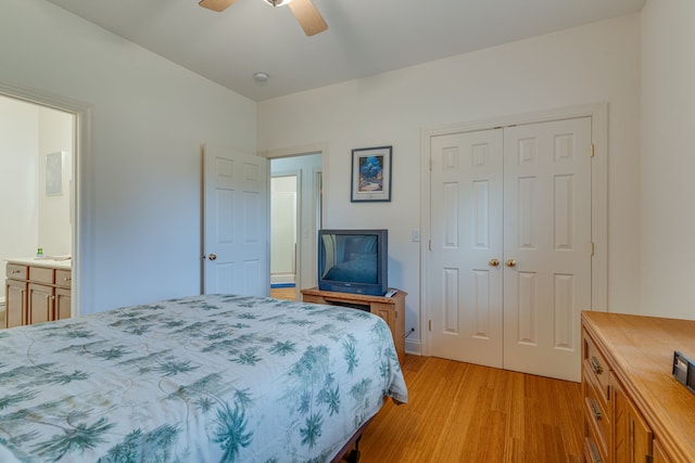 bedroom featuring a closet, ceiling fan, ensuite bathroom, and light hardwood / wood-style flooring