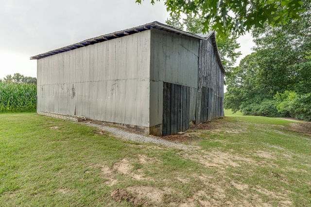 view of outbuilding featuring a lawn