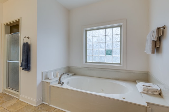 bathroom with separate shower and tub and tile patterned floors